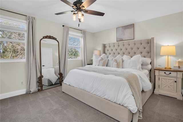 bedroom featuring light colored carpet, baseboards, and ceiling fan