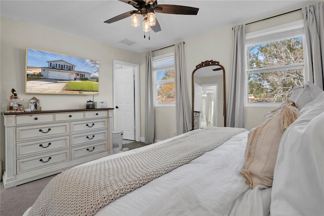 bedroom with a ceiling fan and carpet floors