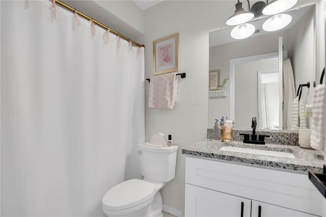 full bathroom with toilet and vanity