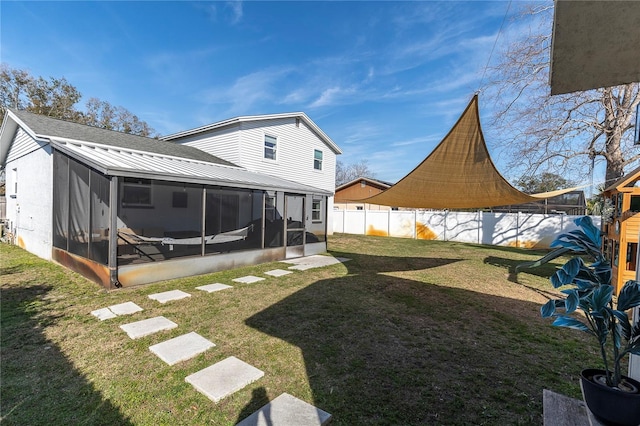 exterior space featuring a fenced backyard and a sunroom