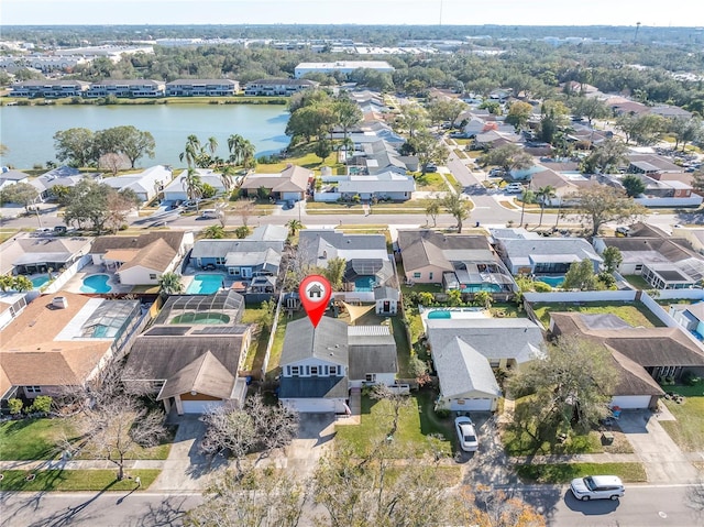 drone / aerial view with a residential view and a water view