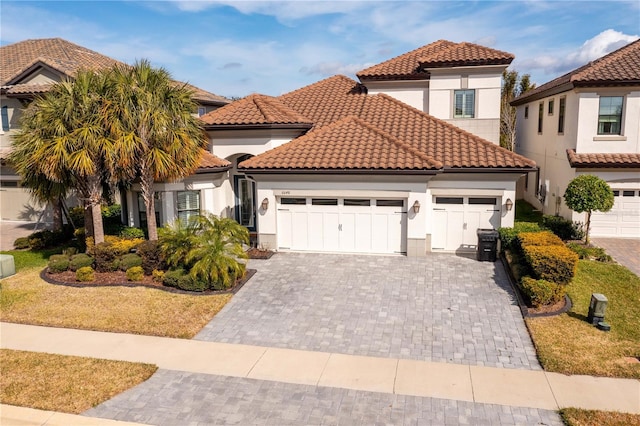 mediterranean / spanish-style home with a garage