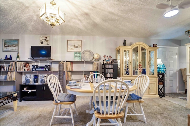 dining room featuring carpet flooring, a notable chandelier, and a textured ceiling