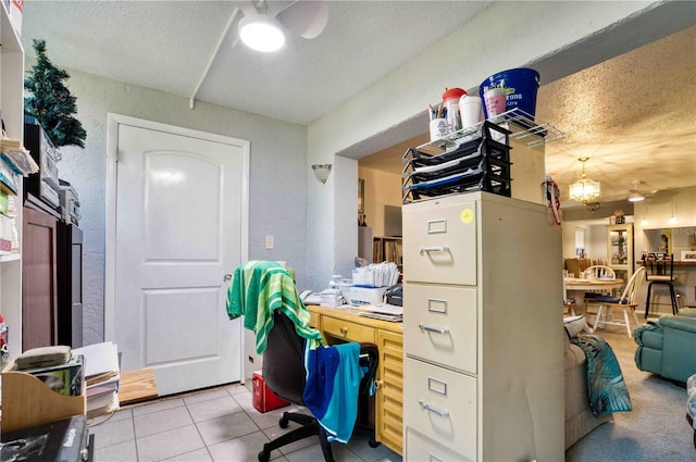 tiled home office featuring a textured ceiling