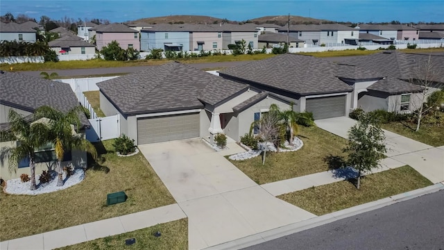 view of front of home with a front lawn and a garage