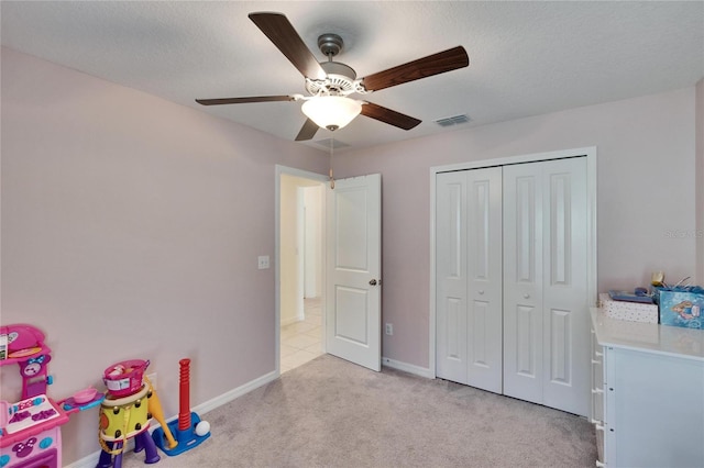 bedroom with light carpet and a textured ceiling