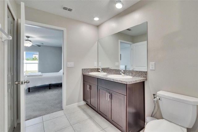 bathroom with ceiling fan, vanity, toilet, and tile patterned floors