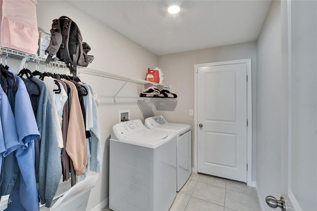 washroom with washing machine and dryer and light tile patterned floors