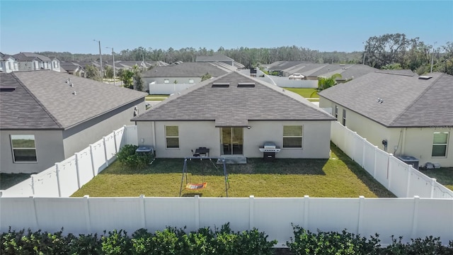 rear view of house featuring a yard