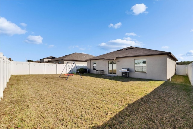 rear view of house featuring a lawn