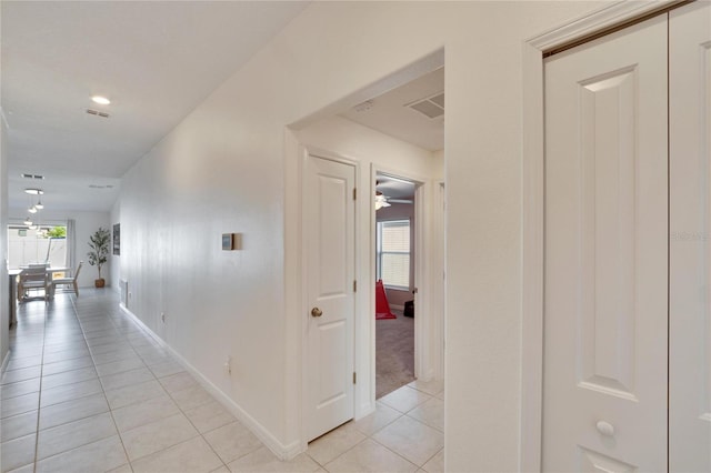 hallway with light tile patterned floors