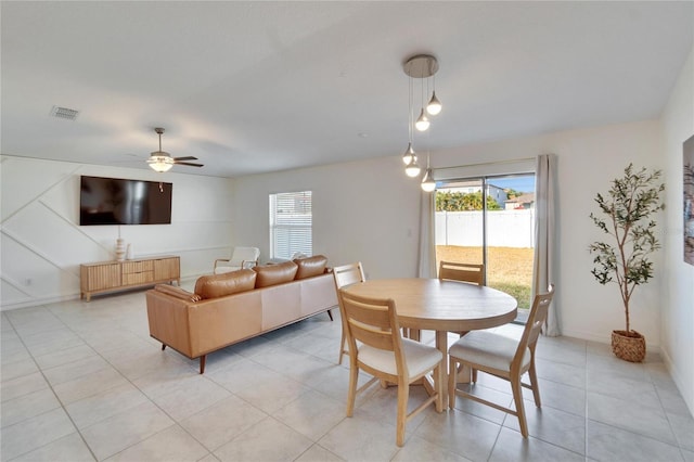 tiled dining space with ceiling fan