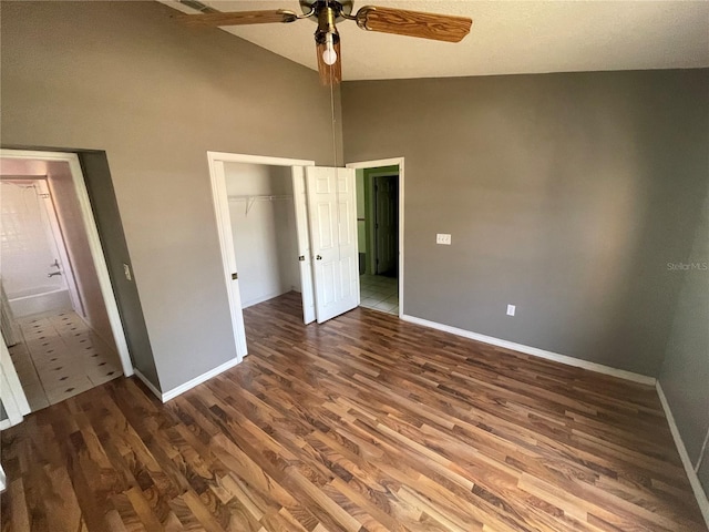 unfurnished bedroom with vaulted ceiling, dark wood-type flooring, ceiling fan, and a closet