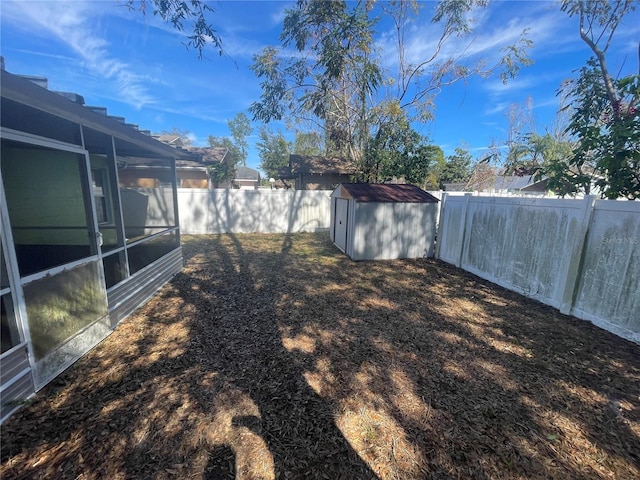 view of yard with a sunroom and a shed