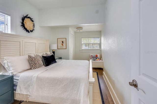 bedroom with hardwood / wood-style floors and a closet