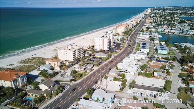 drone / aerial view featuring a beach view and a water view