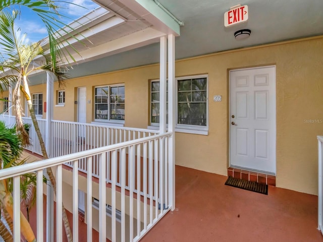 19417 Gulf Blvd Unit B205, Indian Rocks Beach, FL 33785 - view of exterior entry featuring stucco siding and a porch
