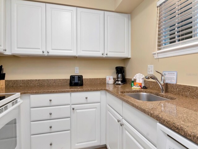 19417 Gulf Blvd Unit B205, Indian Rocks Beach, FL 33785 - kitchen featuring electric range, stone countertops, white cabinetry, and a sink