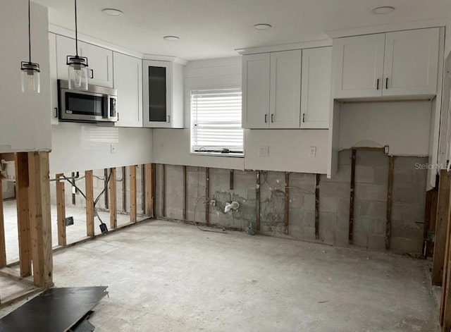 kitchen with decorative light fixtures and white cabinets