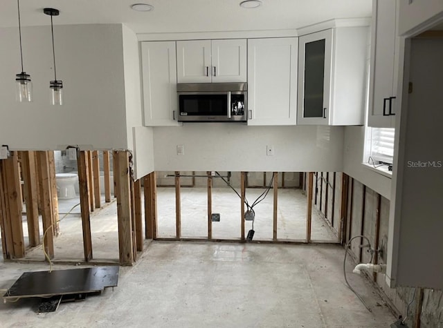 kitchen featuring white cabinetry and decorative light fixtures