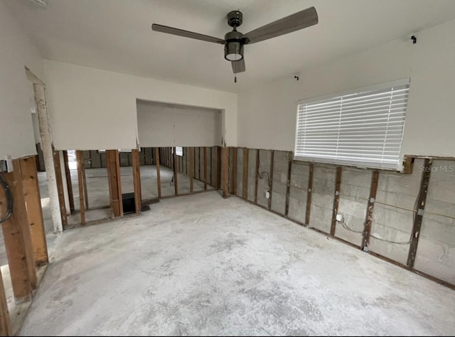 interior space with ceiling fan