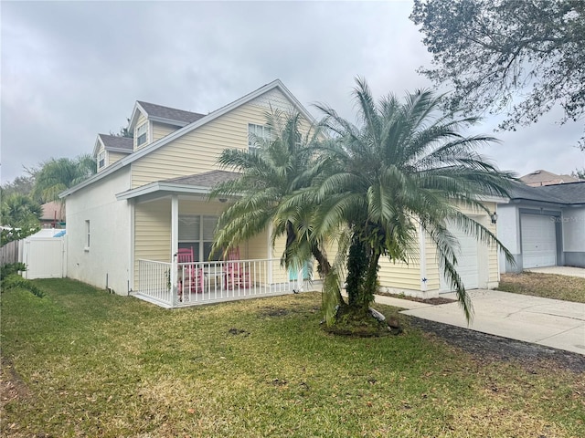 view of front of property with a porch, a garage, and a front yard