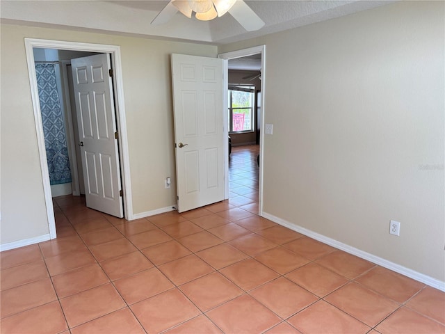 unfurnished bedroom with light tile patterned floors and ceiling fan