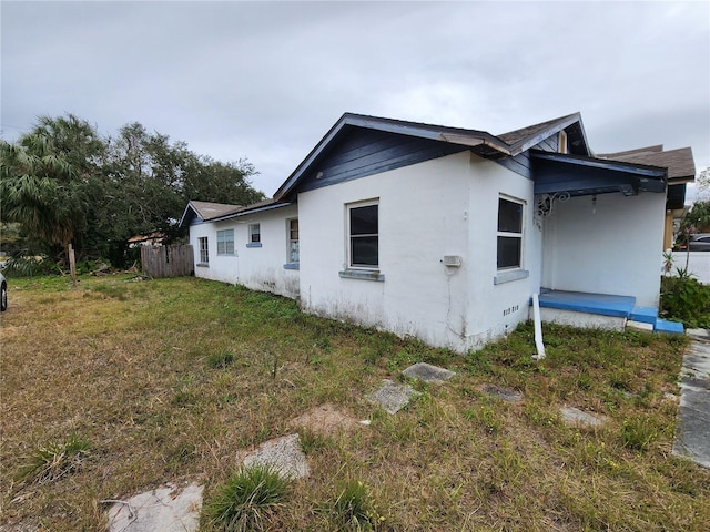 view of property exterior with a yard