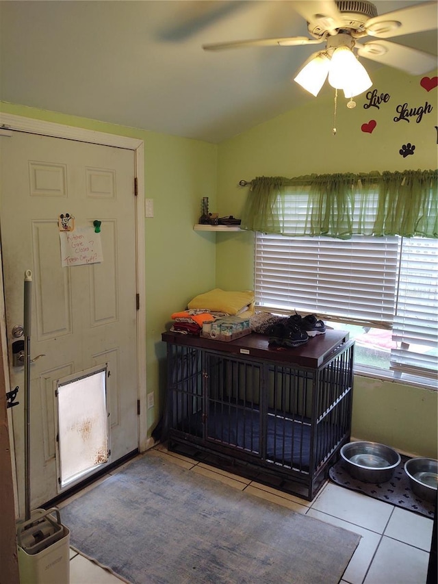 tiled bedroom with lofted ceiling and ceiling fan