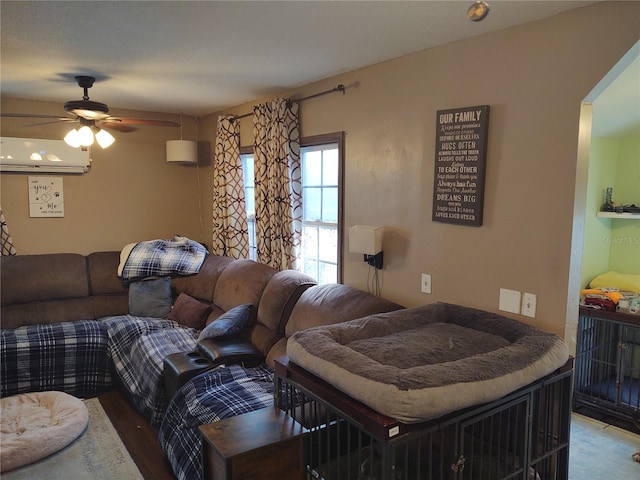 living room with ceiling fan and a wall unit AC