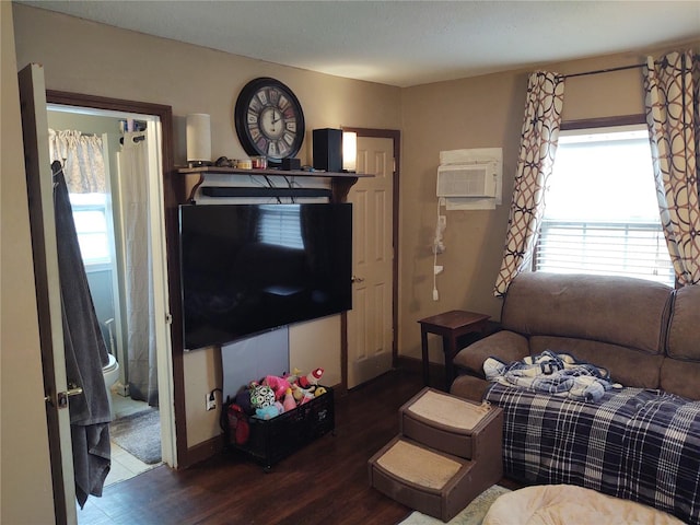 living room featuring a wall mounted air conditioner and dark hardwood / wood-style floors