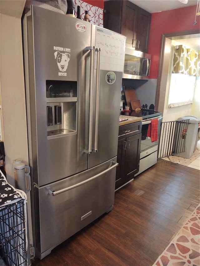 kitchen with stainless steel appliances, dark wood-type flooring, and dark brown cabinetry