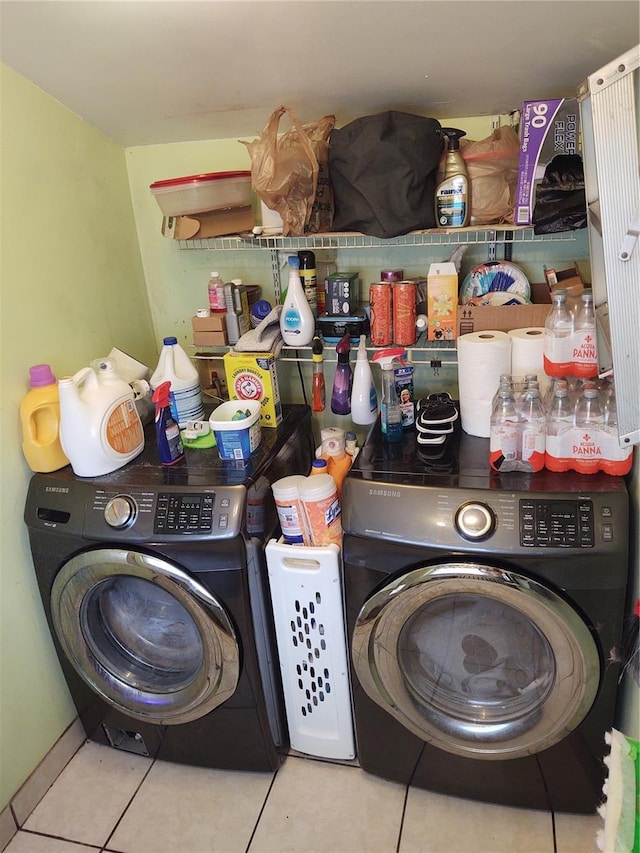 laundry area featuring washer / dryer and light tile patterned floors