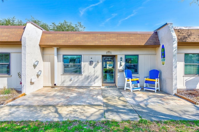 doorway to property featuring a patio area