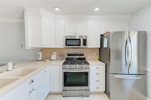 kitchen featuring white cabinetry, sink, decorative backsplash, and appliances with stainless steel finishes