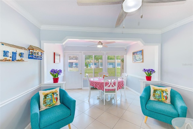 tiled dining space featuring ornamental molding and ceiling fan