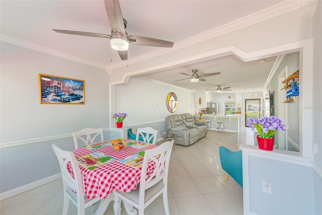 dining room with light tile patterned floors, ornamental molding, and ceiling fan