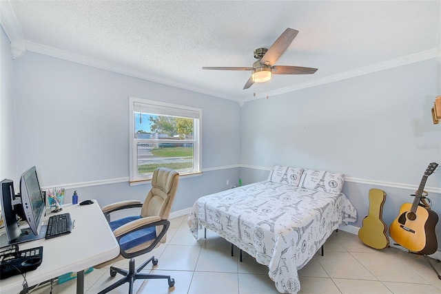 tiled bedroom featuring ornamental molding, ceiling fan, and a textured ceiling