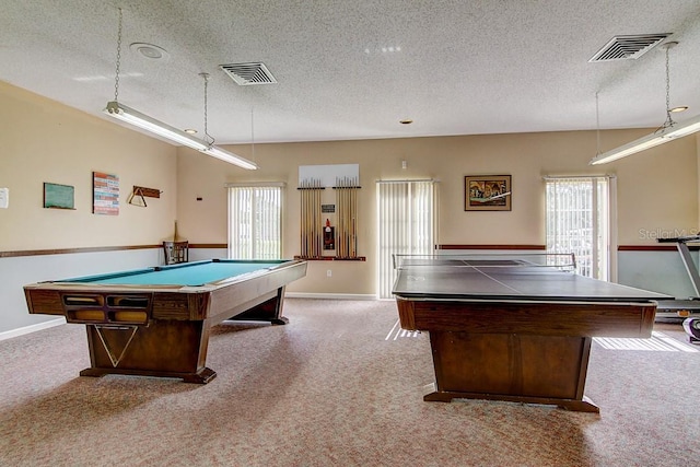 recreation room featuring a wealth of natural light, a textured ceiling, and carpet