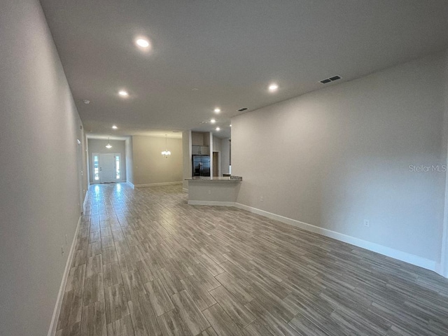 unfurnished living room with a large fireplace and hardwood / wood-style floors