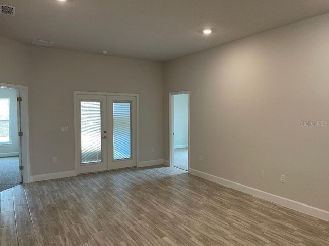 unfurnished room featuring light wood-type flooring and french doors