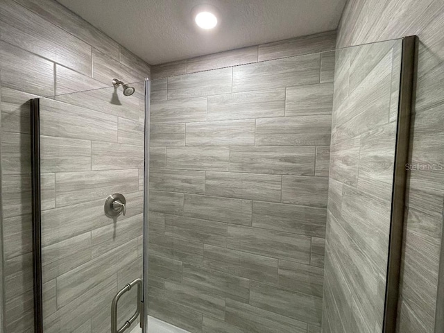 bathroom with a shower with shower door