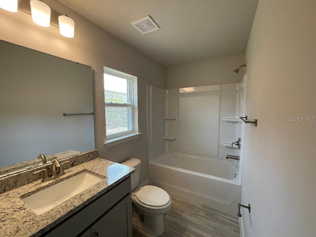 full bathroom with vanity, hardwood / wood-style flooring, toilet, and shower / bath combination