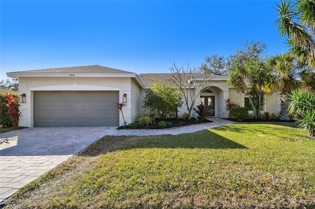 ranch-style home with a garage and a front lawn