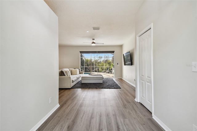 interior space with ceiling fan and light hardwood / wood-style floors