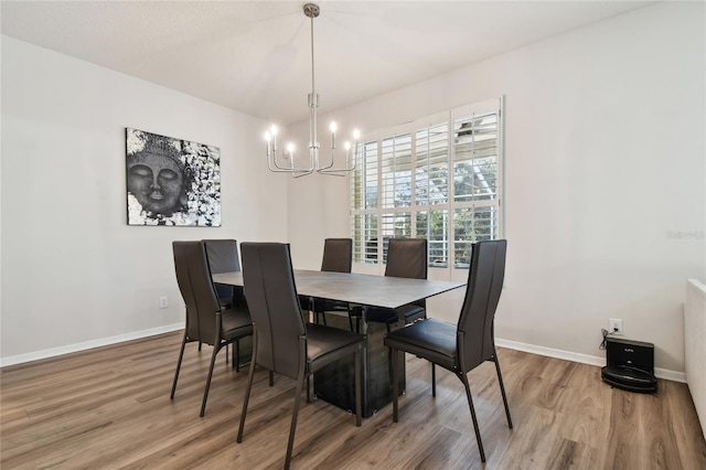 dining space featuring a notable chandelier and wood-type flooring