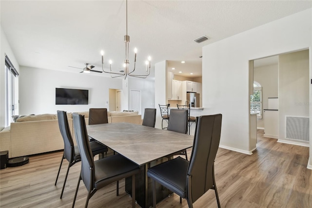 dining room featuring an inviting chandelier and light hardwood / wood-style floors