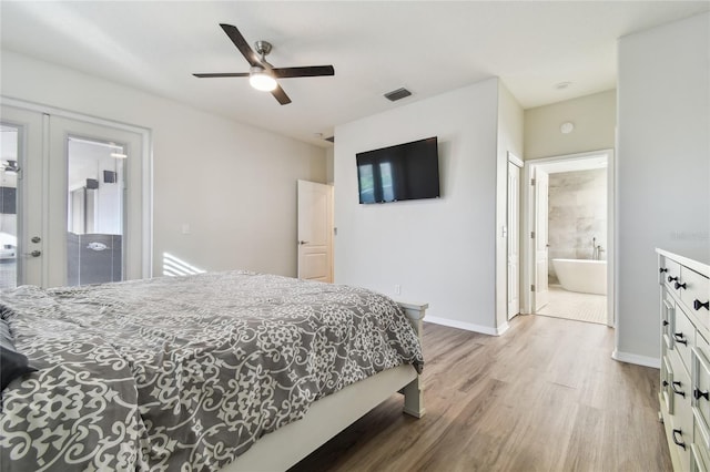 bedroom with ensuite bath, ceiling fan, access to exterior, french doors, and light wood-type flooring