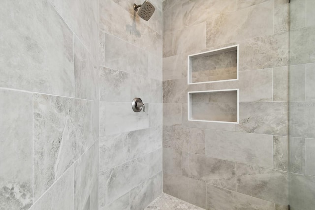 bathroom with a tile shower