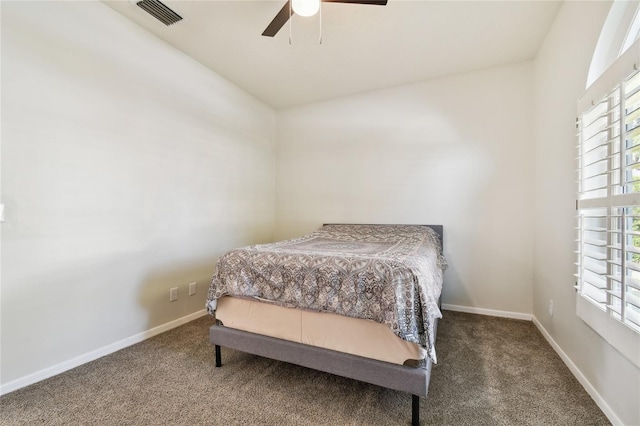 carpeted bedroom with multiple windows and ceiling fan